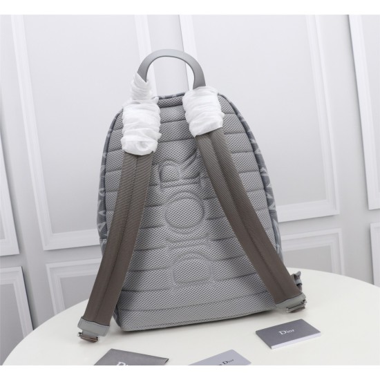 20231126 650 This Rider backpack features a minimalist silhouette and a classic college style exuding vitality. Crafted with gray CD Diamond patterned canvas, inspired by Dior archives, embellished with smooth cowhide leather, and adorned with the 